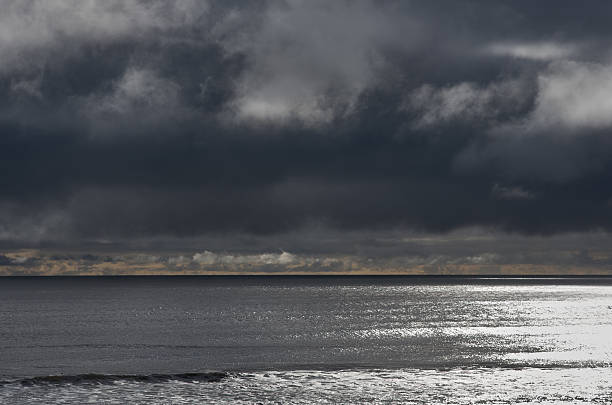 istock Dark cloudy sky sea in evening sun light 489557986