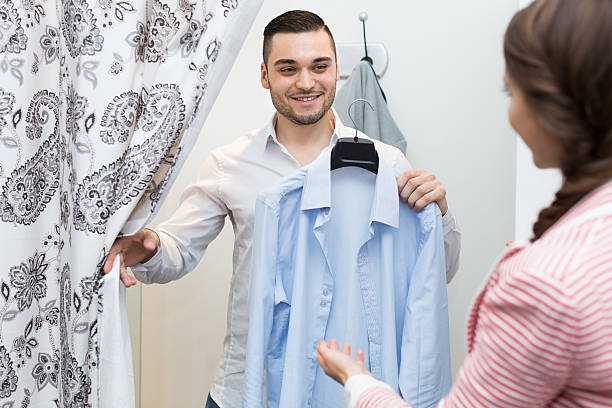 istock Young couple at fitting room 489562232