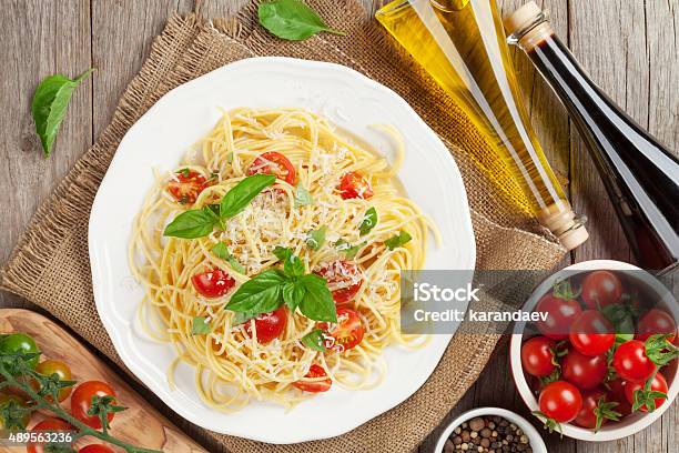 Spaghetti Pasta With Tomatoes And Basil Stock Photo - Download Image Now - 2015, Above, Burlap