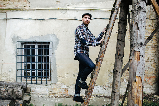 man in selvedge jeans standing on the ladder