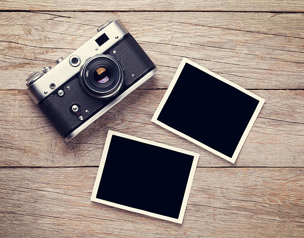 istock Vintage film camera and two blank photo frames 489564580