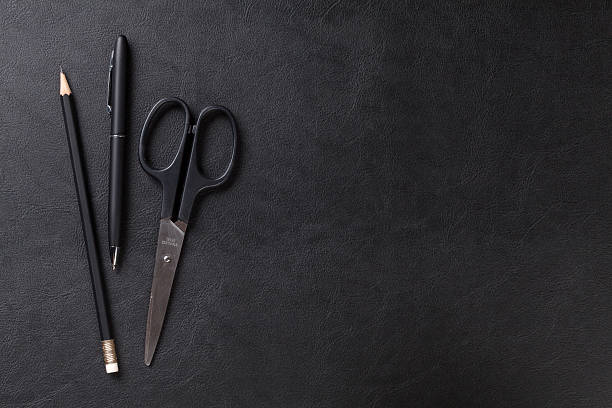 istock Office leather desk table with pen, pencil and scissors 489564792