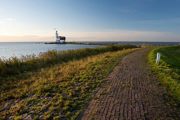 istock Idyllic lighthouse from the dike at sunrise 489566098