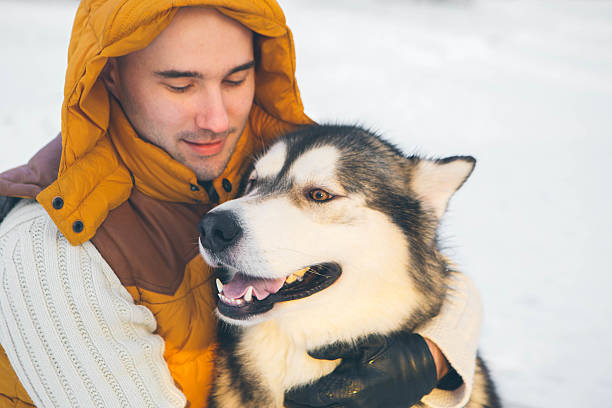 istock Man walking with dog winter time with snow 489568202
