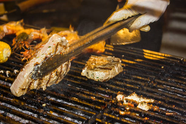 istock Chef cooking beef steak on the barbecue grill 489568694