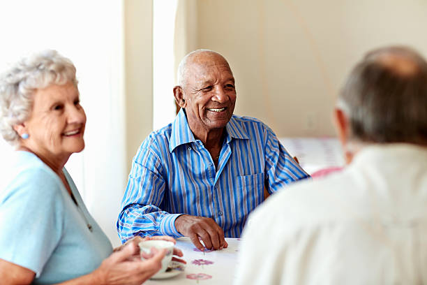 senior man having coffee with friends - hospitable fotografías e imágenes de stock