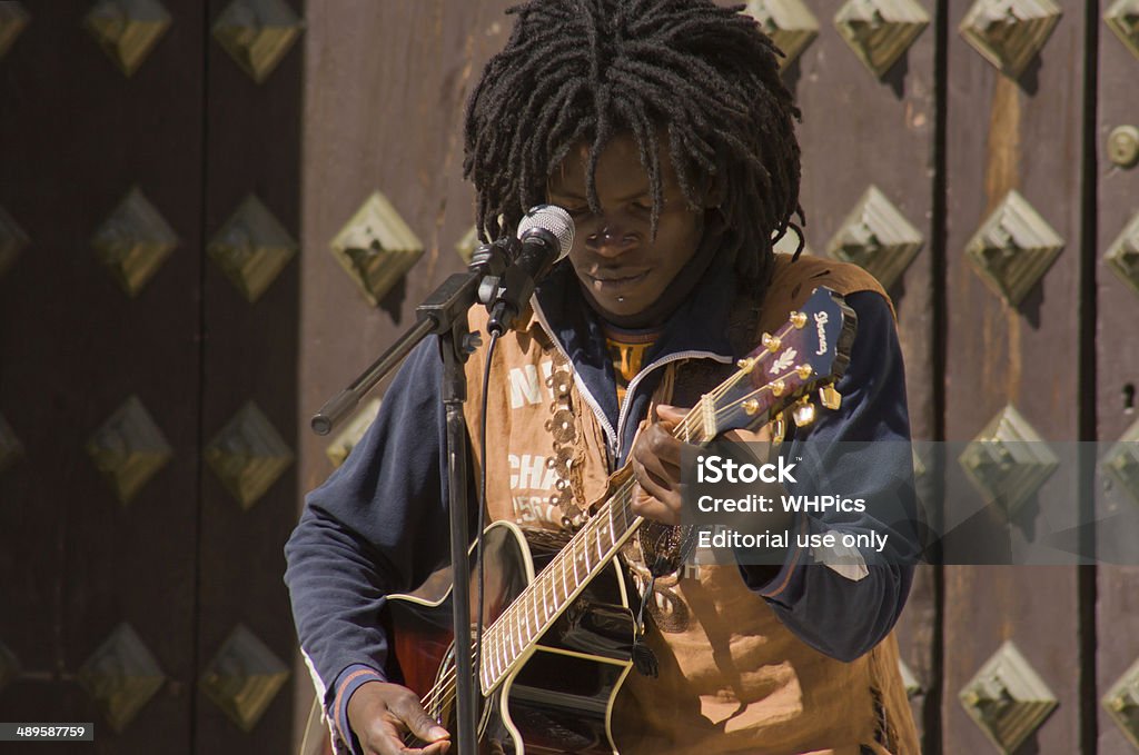 Rasta guitar Granada, Spain, March 7, 2009: Black rasta street musician man playing at Granada downtown, Spain on 7 March 2009 30-39 Years Stock Photo