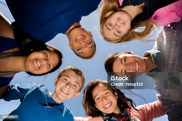 Teenagers Diverse Group Of Friends Huddle Outside Together Blue Sky Stock Photo - Download Image Now