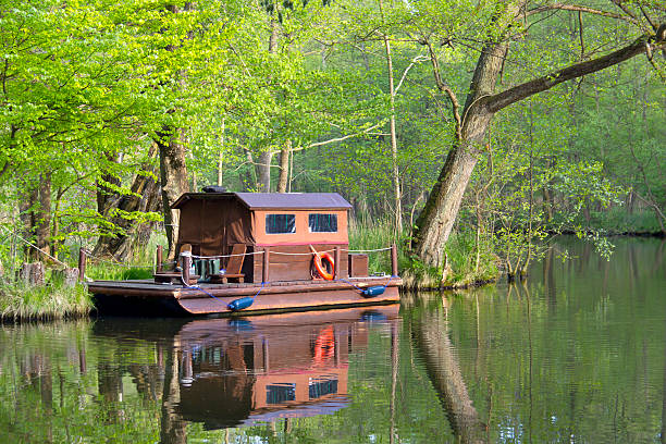 Old rowing boat and reflection in a wooded area of the River Lee in Hertfordshire