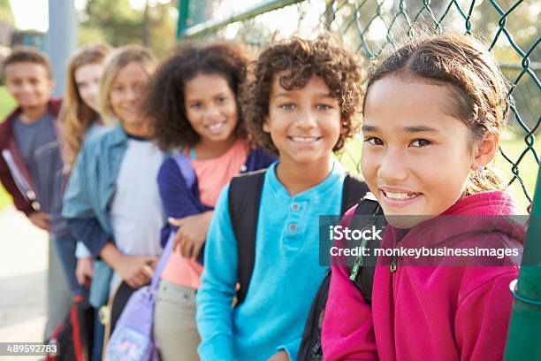 Grupo De Jóvenes Amigos En El Patio De Juegos Para Niños Foto de stock y más banco de imágenes de Niño