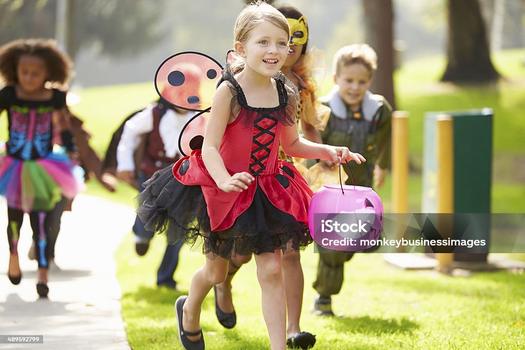 Children In Fancy Costume Dress Going Trick Or Treating Children In Fancy Costume Dress Going Trick Or Treating Running Halloween Stock Photo