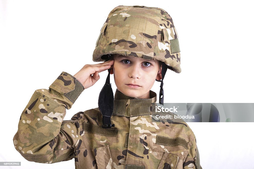 Saluting soldier. Saluting soldier. Young boy dressed like a soldier isolated on white Child Stock Photo