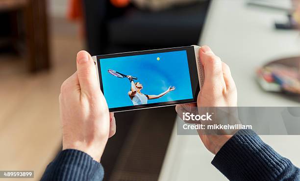 Streaming Tennis Match On A Mobile Phone Stock Photo - Download Image Now - Mobile Phone, Watching, Portable Information Device