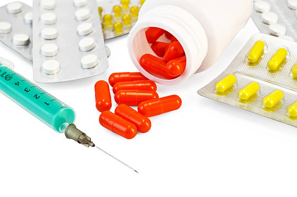 istock Capsule red with drugs and a syringe 489594023