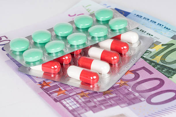 istock capsules and pills in blister with euro banknotes 489599704