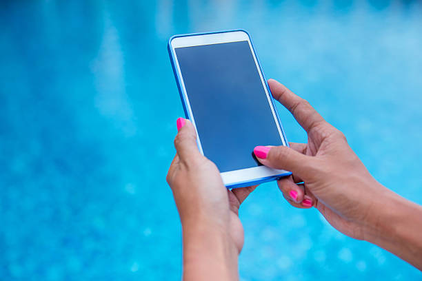istock Close up woman hands using smartphone with a blue background 489600020