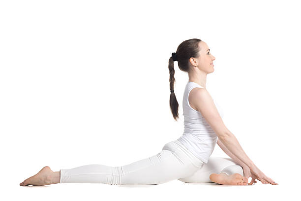 Swan Pose Sporty beautiful young woman in white sportswear sitting in easy variation of One Legged King Pigeon Pose - Eka Pada Rajakapotasana 1 (Swan - yin posture), studio full length, isolated raja stock pictures, royalty-free photos & images