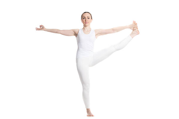 back side of young woman flexible in try to training yoga with balance stand and stretching poses isolated on white background and clipping path. yoga training concept.