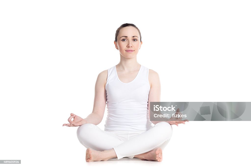 Sukhasana yoga pose Sporty beautiful young woman practicing yoga, Sitting in Easy (Decent, Pleasant Pose), Sukhasana, asana for meditation, pranayama, breathing, studio full length isolated shot, front view 2015 Stock Photo