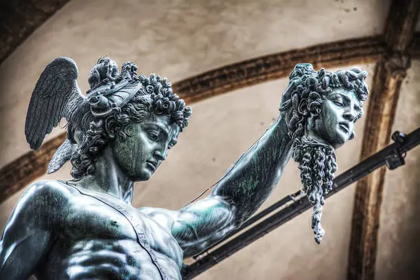 detail of Perseo holding Medusa head statue in Loggia de Lanzi, Florence