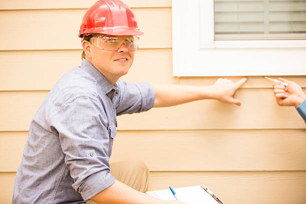 istock Inspector or blue collar workers examines building wall, window. Outdoors. 489606434