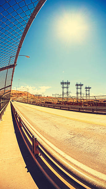 Retro toned road and energy infrastructure against sun, fisheye concept photo, Powell Lake region, Arizona, USA.