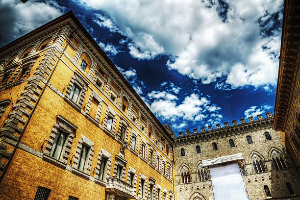 Salimbeni and Tantucci Palaces in Siena under a cloudy sky