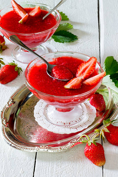 istock Strawberry jelly with fresh fruit on a white wooden background 489607980