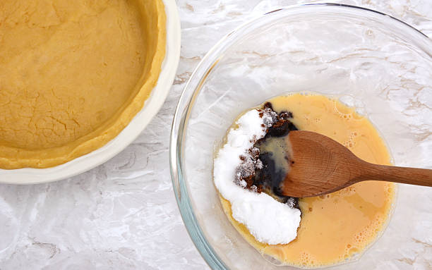 istock Stirring sugar into beaten egg for pumpkin pie filling 489608228