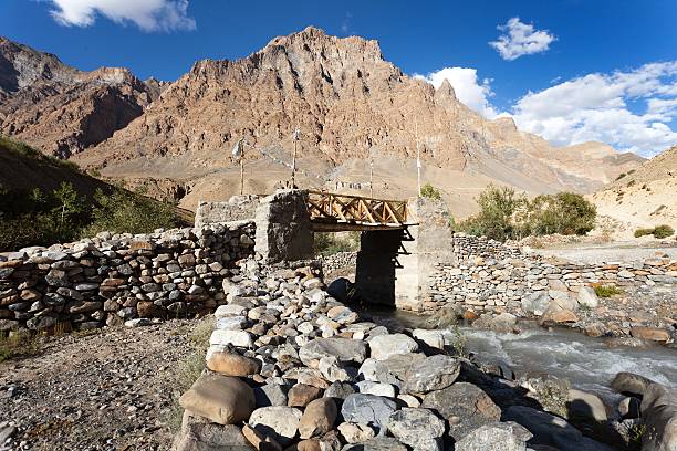 woody and stone bridge with prayer flags on Zanskar trek woody and stone bridge with prayer flags on Zanskar trek, Ladakh, jammu and Kashmir, India flaglets stock pictures, royalty-free photos & images