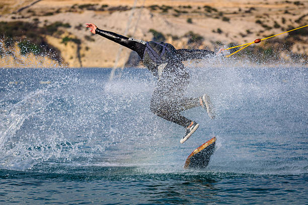 Wakeskater in a cable park doing tricks stock photo