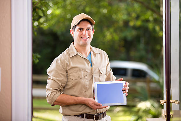 istock Service Industry: Repairman at customer's front door. Digital tablet. 489610672