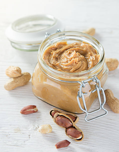 istock Peanut butter on wooden ground 489612644