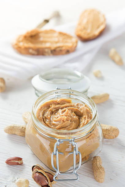 istock Peanut butter on wooden ground 489612670