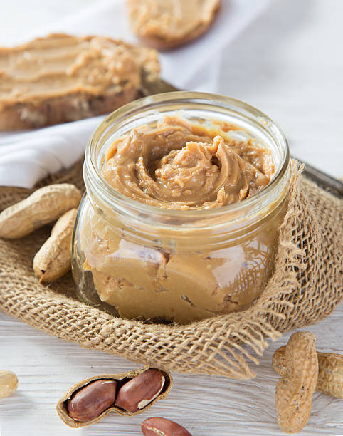 istock Peanut butter on wooden ground 489612698
