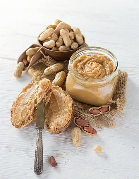 istock Peanut butter on wooden ground 489612744
