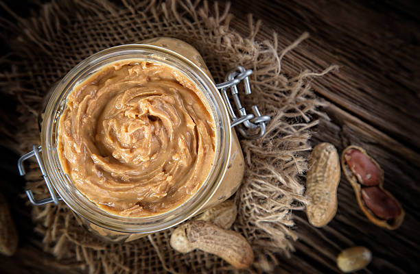 istock Peanut butter on wooden ground 489612838