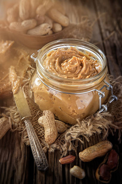 istock Peanut butter on wooden ground 489612880