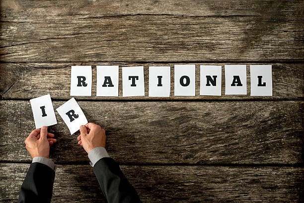 istock Male hands taking away letters IR from the word Irrational 489614140