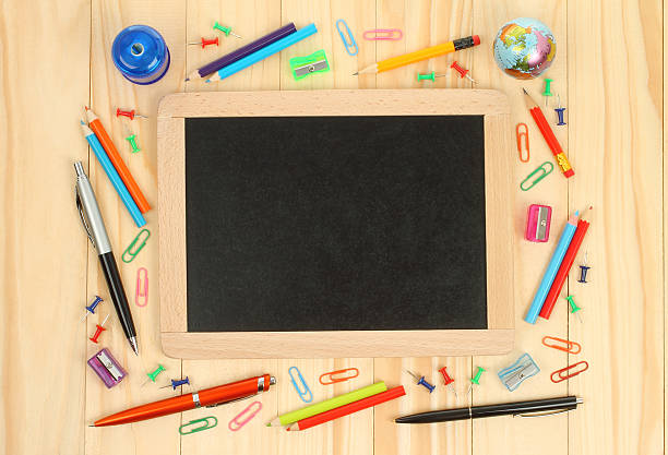 istock Chalkboard with school office supplies 489614410