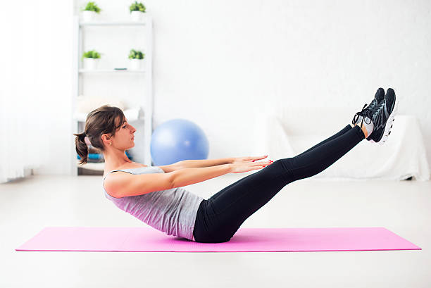 istock Woman doing abdominal exercise on mat at home stretching pilates 489632880