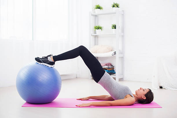 istock sporty woman doing pilates exercise lifting her pelvis with fit 489632928