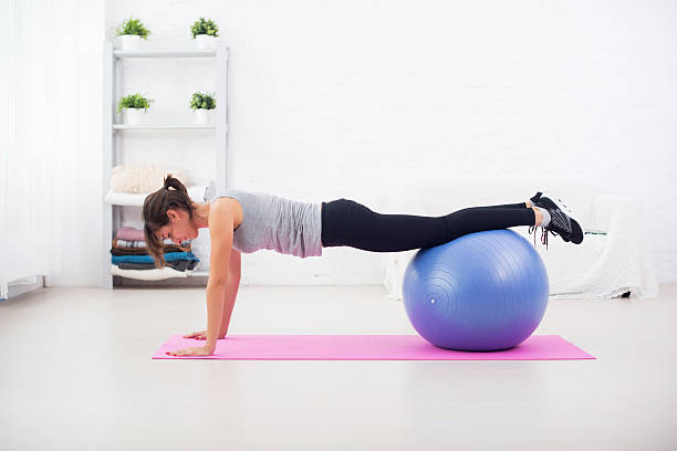 istock Woman doing push-ups on the floor with fit ball 489632952
