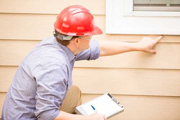 istock Inspector or blue collar workers examines building wall, window. Outdoors. 489634602