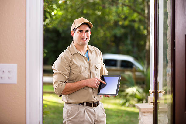 istock Service Industry: Latin descent repairman at customer's front door. 489635306