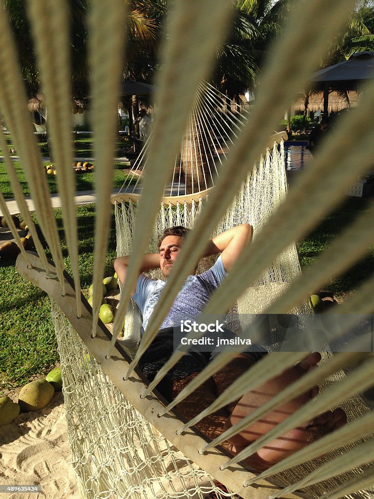 Relaxation Man sleeping on a hammock on beach resort, Riviera Maya, Mexico 2015 Stock Photo