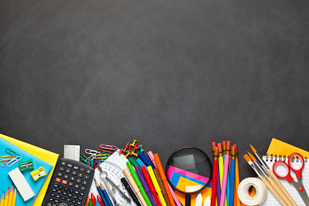istock Black chalkboard with school supplies at the bottom border 489635584