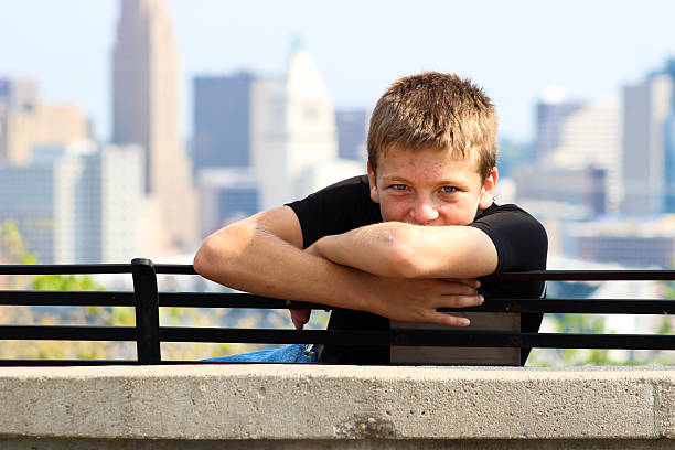 Young Boy on Bench Poses For Camera Against Cincinnati Skyline