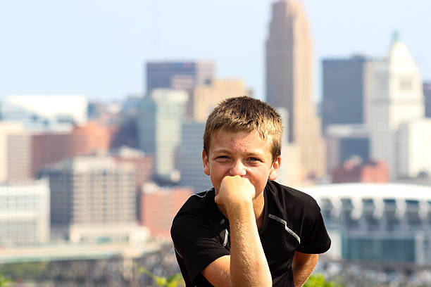 istock Young Boy Poses For Camera Against Backdrop of Cincinnati Skyline 489636818