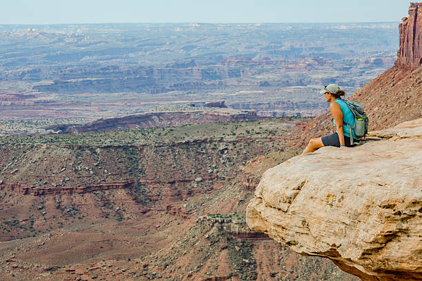 istock Female Hike Over Canyon Narrow 489637170